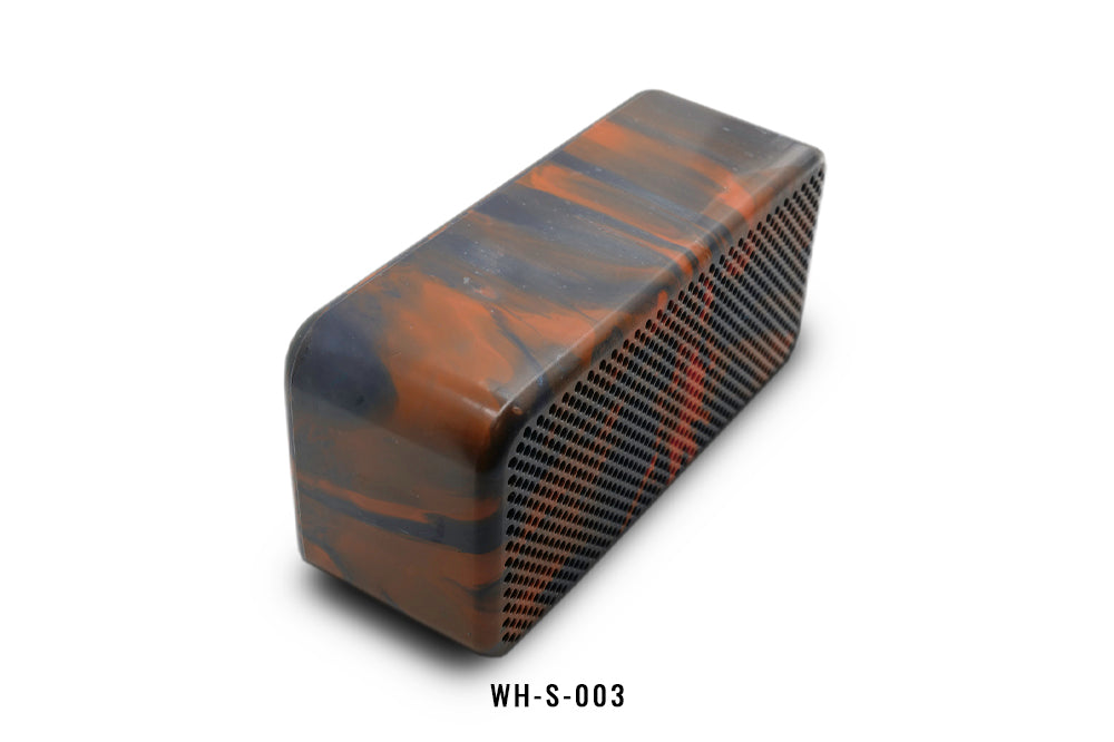 Rectangular orange and black patterned speaker on a white background