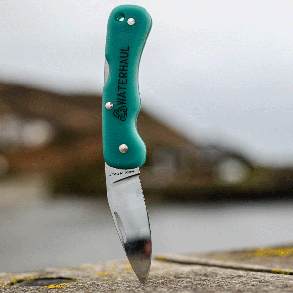 Teal pocket knife with 'Waterhaul' branding on a blurred background