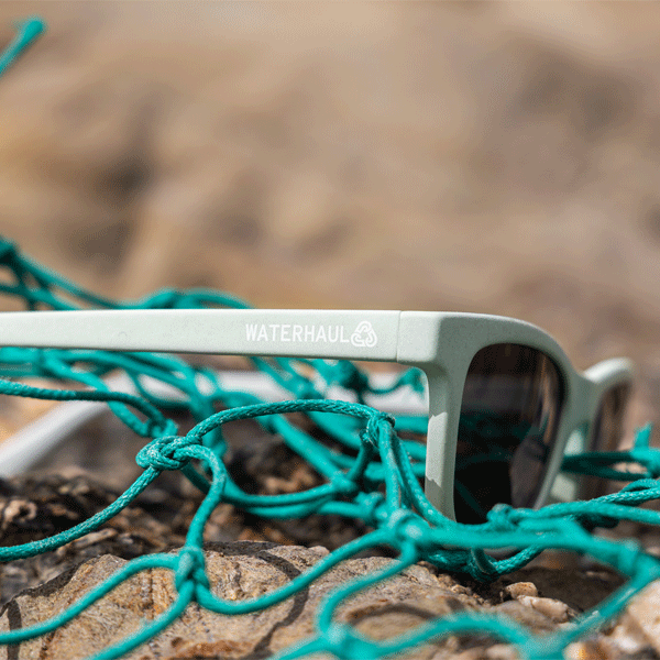 Sunglasses with 'Waterhaul' branding on a fishing net surface