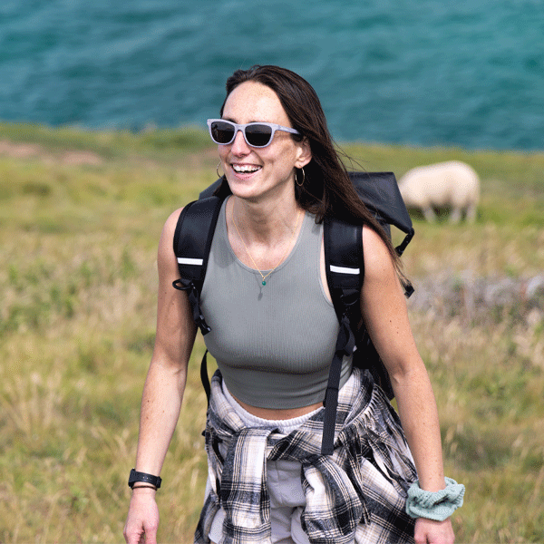 Woman wearing cat-eye sunglasses with a natural background