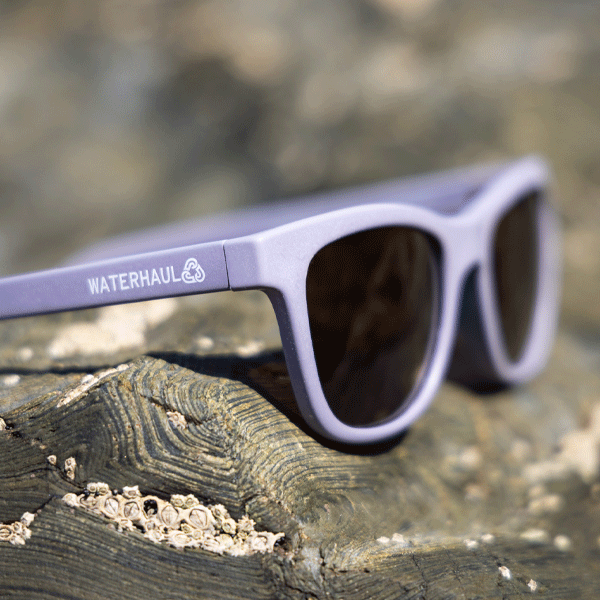 Sunglasses with 'Waterhaul' branding on a rocky surface