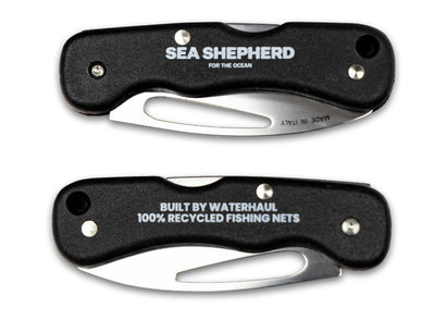 Two folding knives with Sea Shepherd branding on a white background